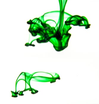 Vegetable ink poured into water with white background.