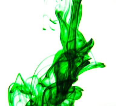 Vegetable ink poured into water with white background.