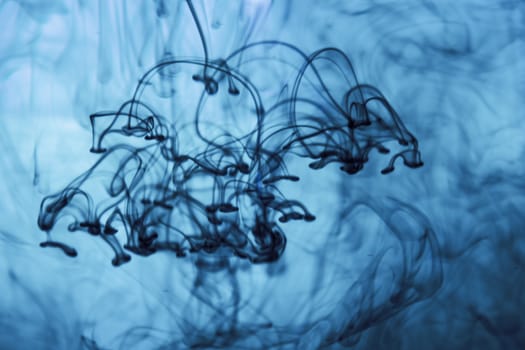 Vegetable ink poured into water with white background.