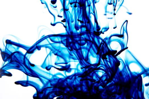Vegetable ink poured into water with white background.