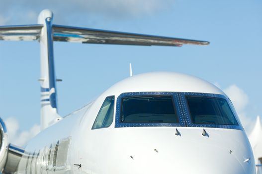 Front detail of white corporate jet airplane