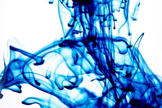 Vegetable ink poured into water with white background.