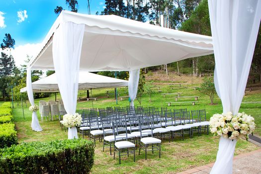 wedding marquee with bouquets of roses