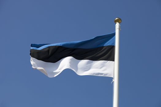 Estonia flag flying in the wind, deep blue sky