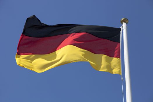 Germany flag flying in the wind, deep blue sky
