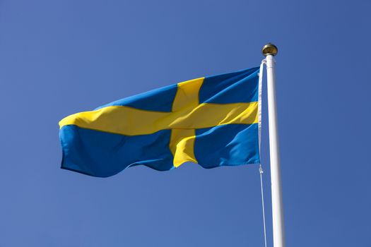 Sweden flag flying in the wind, deep blue sky