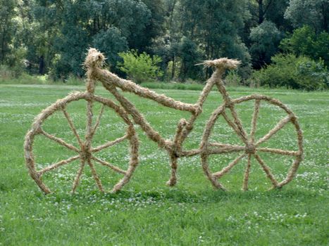 bike sculpture of straw on the lawn         