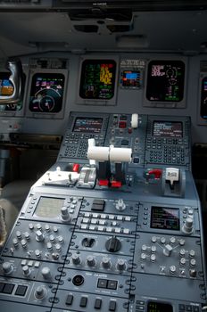 Cockpit of 100 seat, 2 engine jet airliner. Shallow depth of field with the nearest instruments in focus.