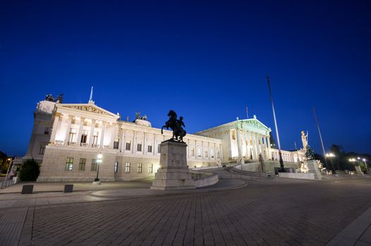 VIENNA, AUSTRIA - AUGUST 4, 2013: Austrian Parliament Building and The Athena Fountain at night.