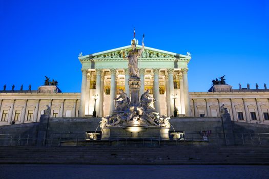 VIENNA, AUSTRIA - AUGUST 4, 2013: Austrian Parliament Building and The Athena Fountain at night.
