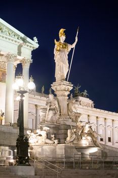VIENNA, AUSTRIA - AUGUST 4, 2013: Austrian Parliament Building and The Athena Fountain at night.