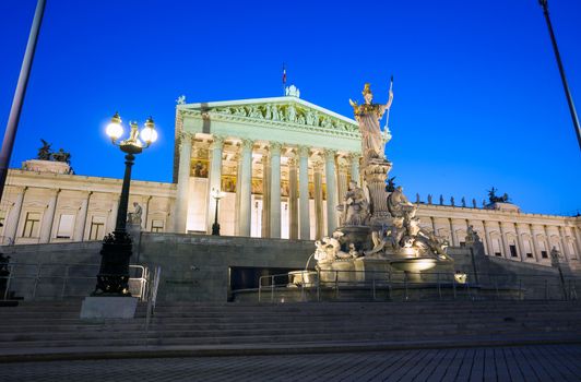 VIENNA, AUSTRIA - AUGUST 4, 2013: Austrian Parliament Building and The Athena Fountain at night.