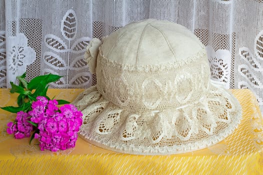 Female hat from linen fabric and lacy fabric for protection against the sun. It is a subject for summer holiday.