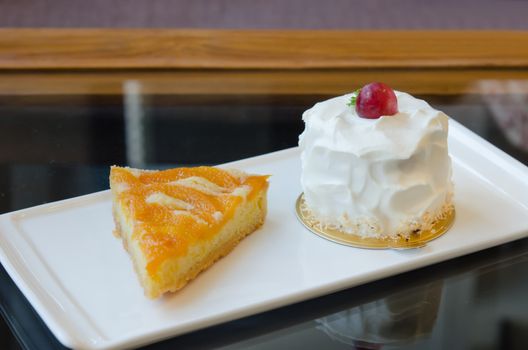 young coconut cake and peach tart on dish