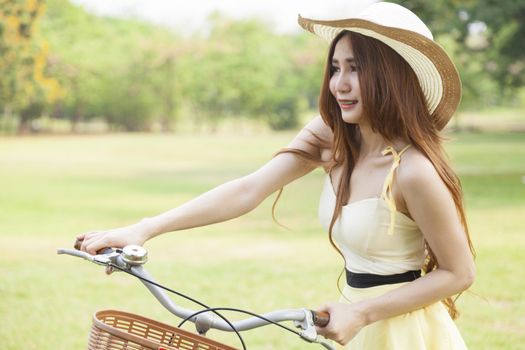 Woman bike handles Strolling on the grass in the park.