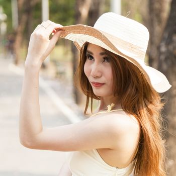 Portrait Asian woman wearing hat Within the park