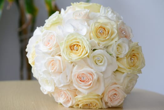 Brides yellow bouquet of rose flowers on wedding day
