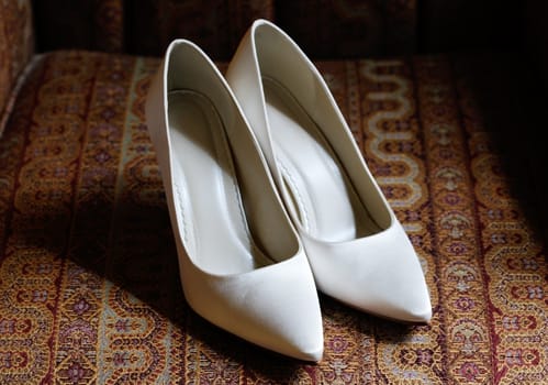 Brides white shoes closeup on wedding day