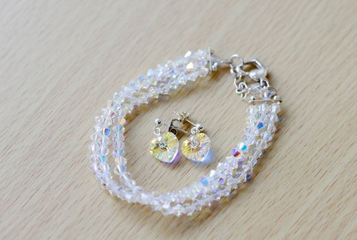 Closeup of brides earings and bracelet showing sparkly detail of heart shapes on wedding day