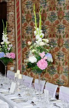 Flower arrangements decorate wedding reception with pink and white bouquets