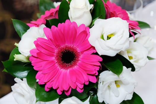 Red and white floral arrangement at wedding reception closeup detail of blooms