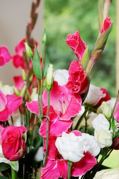 Red and white floral arrangement closeup showing detail at wedding ceremony