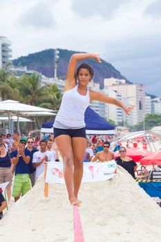 RIO DE JANEIRO - NOVEMBER 03 2012: Slackline contestant on the sands of Copacabana in Rio Elephant Cup tournament, held on November  03, 2012 on Copacabana, Rio de Janeiro, Brazil.