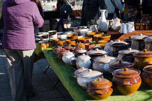 handmade craft clay varnish pots with lids at rural fair