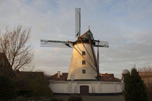 Vintage stone windmill in flanders belgium