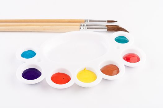 different size paint brushes and color palette