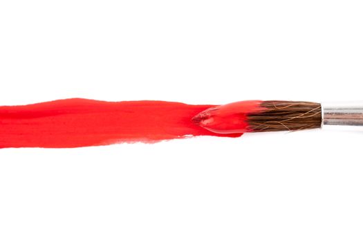 paint brush with red paint on white paper