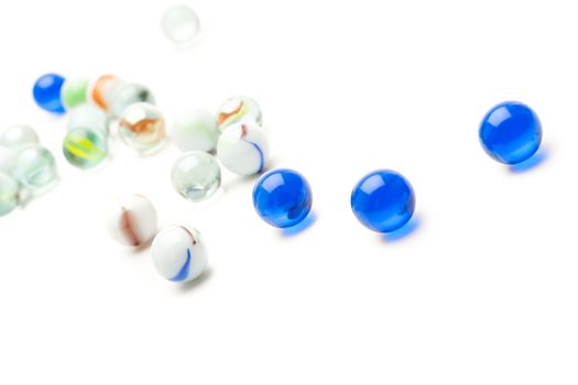 photo of different color marbles on white