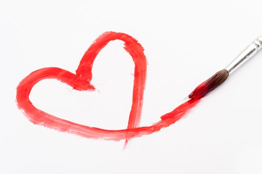 paint brush with red heart painted on white paper
