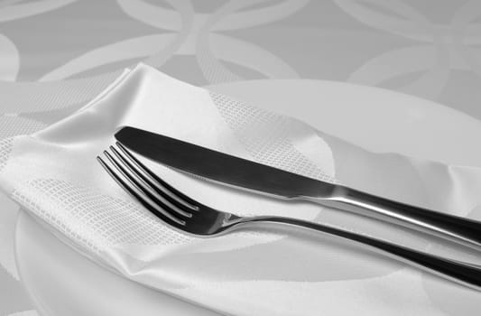 Cutlery knife and fork on a napkin