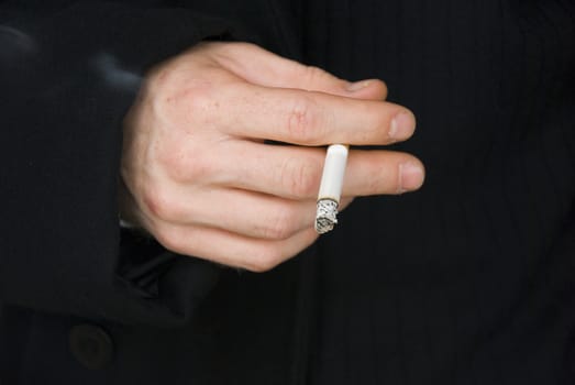 smoker hand closeup with cigarette