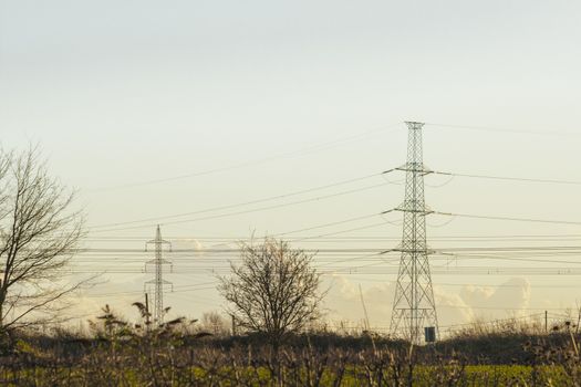 high voltage pylon with cables and landscape