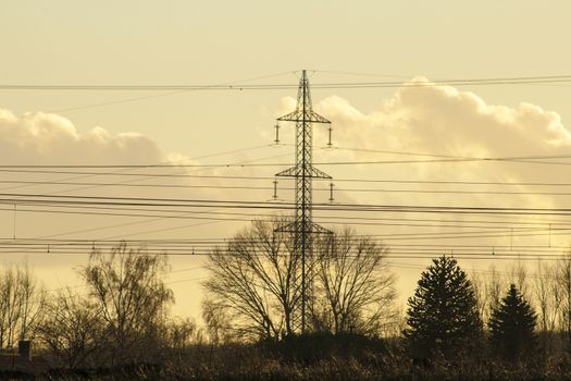 high voltage pylon with cables and landscape