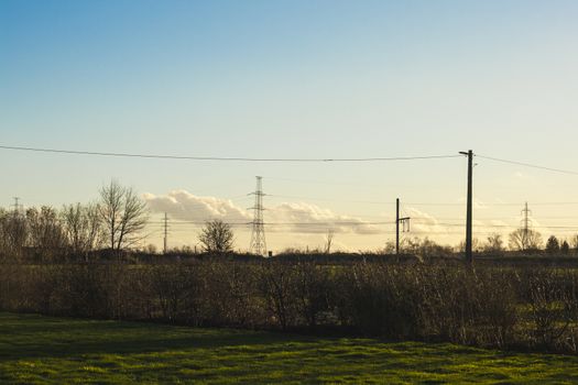 high voltage pylon with cables and landscape