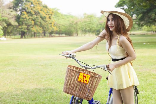 Woman bike handles Strolling on the grass in the park.