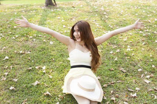 Young woman relaxing on the grass. Park in the warm sunshine.