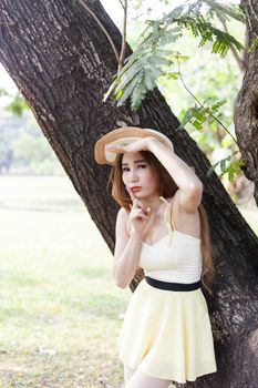 Portrait Asian woman under a tree. Do not stand under trees and ringed.