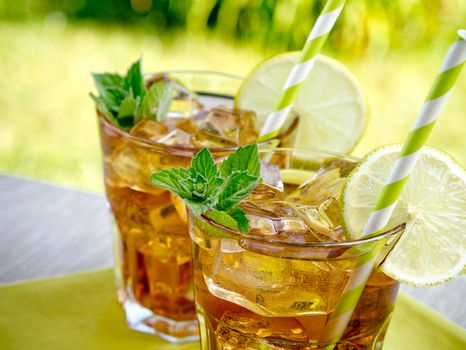 Refreshing peach, lime and mint ice tea served outdoors