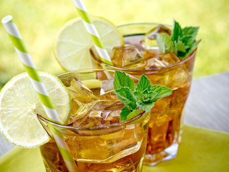 Refreshing peach, lime and mint ice tea served outdoors