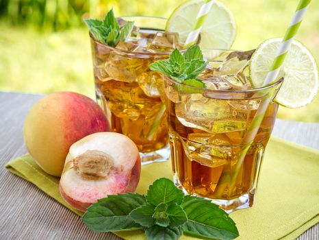 Refreshing peach, lime and mint ice tea served outdoors