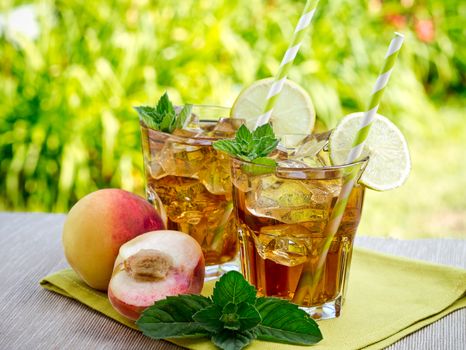 Refreshing peach, lime and mint ice tea served outdoors