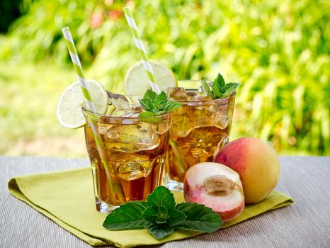 Refreshing peach, lime and mint ice tea served outdoors