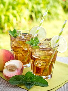 Refreshing peach, lime and mint ice tea served outdoors