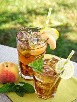 Refreshing peach, lime and mint ice tea served outdoors