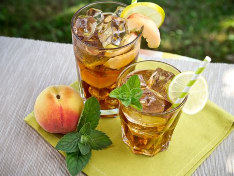 Refreshing peach, lime and mint ice tea served outdoors