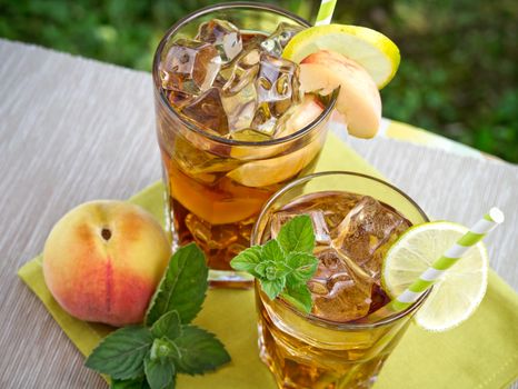 Refreshing peach, lime and mint ice tea served outdoors